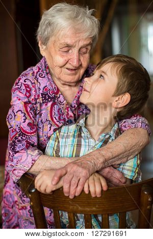 Grandmother hugging her little grandson.