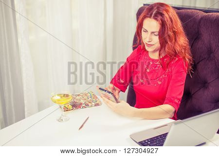 outdoor portrait of a young girl she works as a freelancer in a cafe drinking a delicious hot Cup of coffee from text send mail loads the photo instagram freelancer drinking cappuccino