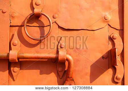 Ancient handle of a door.The lock and the bars.Details of the old device of the bolt of the gate closeup.