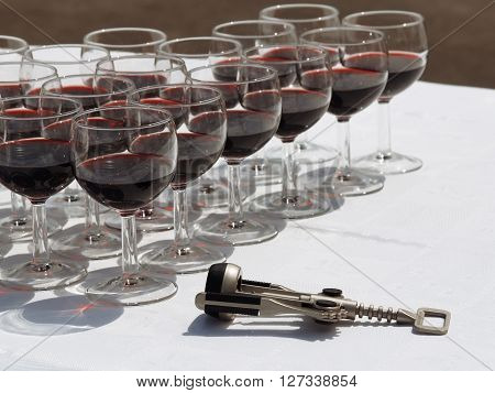 Wineglasses with red wine and the corkscrew