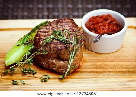 Beautiful Juicy Well Done Steak With Sauce On A Wooden Board