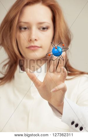 Woman scientist with atom model, research concept