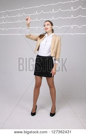 Doctor woman working with cardiogram lines