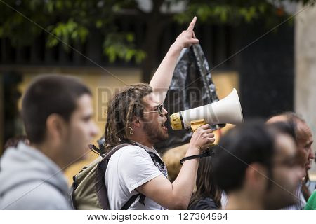 Badajoz Spain - March 29 2012: young demostrator with megaphone protesting against austerity cuts March against the Labor Reform approved by the Government of Spain on March 2012