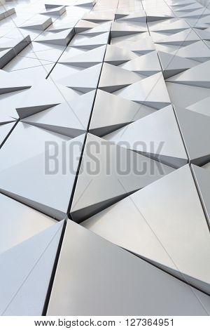 Abstract close-up view of modern aluminum ventilated facade of triangles