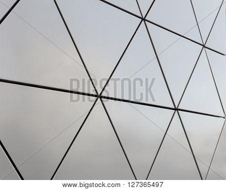 Abstract close-up view of modern aluminum ventilated facade of triangles