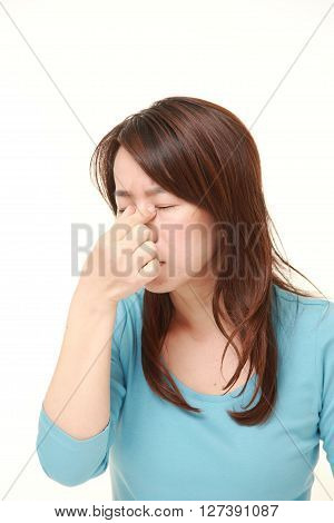Japanese woman suffers from Asthenopia on white background