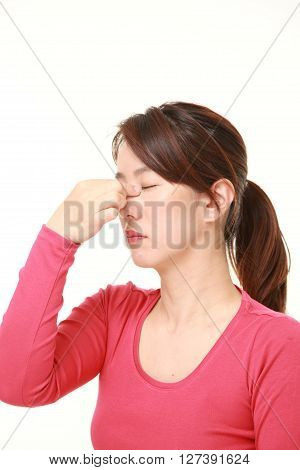 Japanese woman suffers from Asthenopia on white background