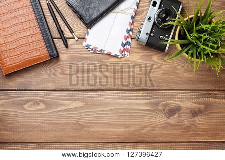 ÃÂ¡amera and supplies on office wooden desk table. Top view with copy space