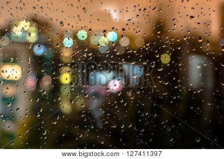 raindrops on the glass in the evening city lights