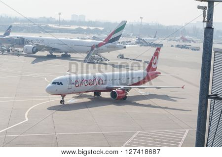 DUESSELDORF NRW GERMANY - MARCH 18 2015: Up Airplane Dusseldorf. View of the tarmac. Large passenger airplane at the gate.