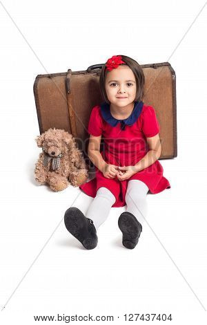 Beautiful little Girl smiling with suitcase and toy bear
