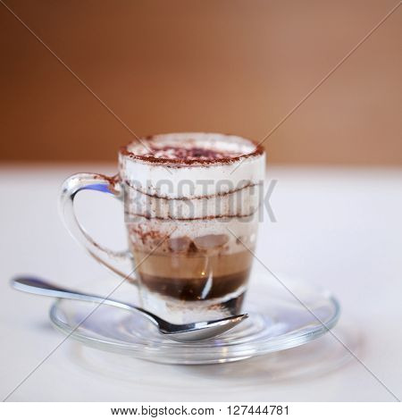 Italian traditional coffee macciato, made in Milan. This beverage contains dark chocolate, hot frothed milk and espresso.