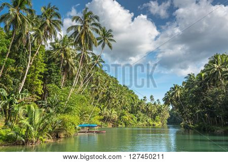 traditional fisherman boat  on a jungle green river Loboc at Bohol island of Philippines