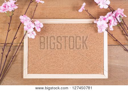 The plastic sakura with cork board on plank