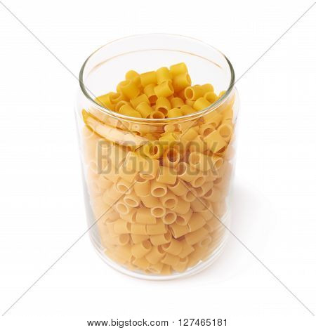 Glass jar filled with dry ditalini yellow pasta over isolated white background