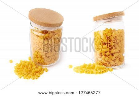 Set of glass jar filled with dry ditalini yellow pasta over isolated white background, different foreshortenings