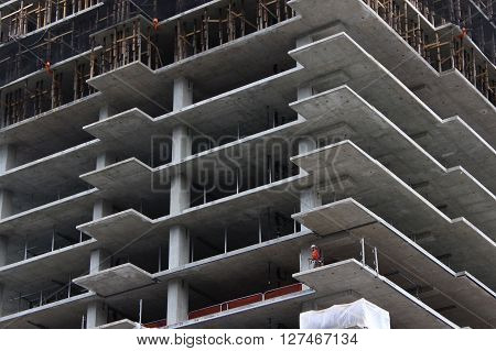Seattle, WA - March 10, 2016: A construction worker works on an unfinished high-rise condo building in Seattle, WA.
