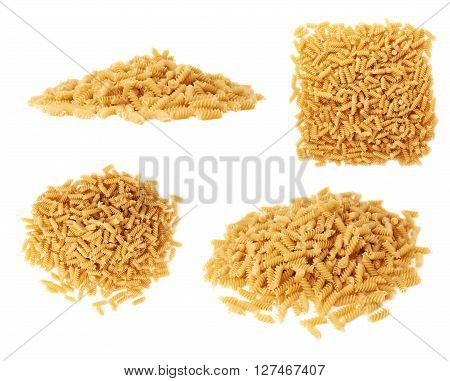 Pile of dry rotini yellow pasta over isolated white background