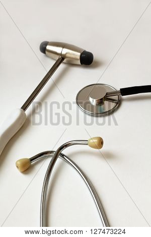 close-up view of stethoscope and neurological hammer