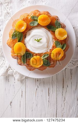 Savarin French Dessert With Apricots And Whipped Cream. Vertical Top View