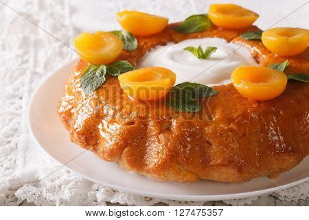 French Pastries: Savarin With Decorated Apricots And Mint Close-up. Horizontal
