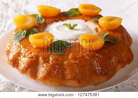 French Dessert: Savarin With Apricots And Mint Close-up. Horizontal