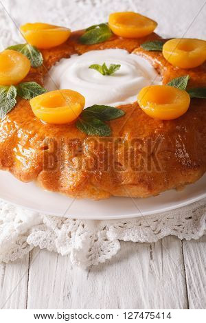 French Savarin Cake Decorated With Apricots And Mint Close-up. Vertical