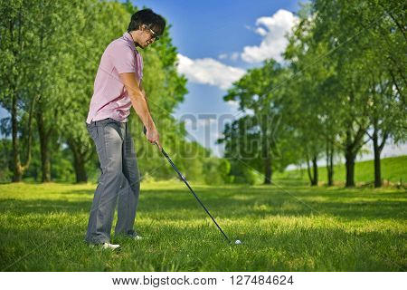 Golf player preparing to play a shot
