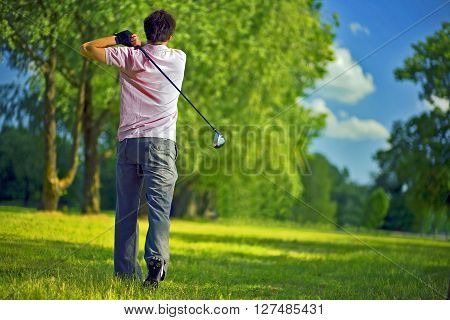 Golf player preparing to play a shot