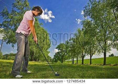 Golf player preparing to play a shot