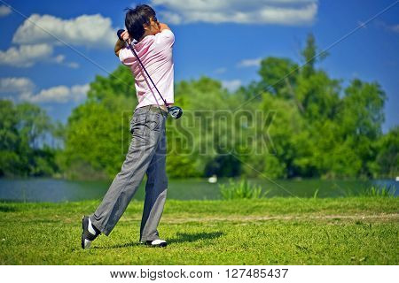 Golf player preparing to play a shot