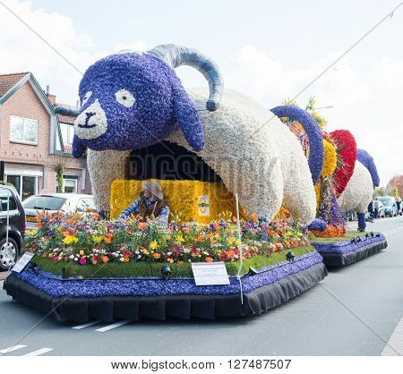HILLEGOM, THE NETHERLANDS - APRIL 23, 2016: Moving platform with a frame made in a form of a goat decorated with spring flowers. Taking part in the  traditional flowers parade 