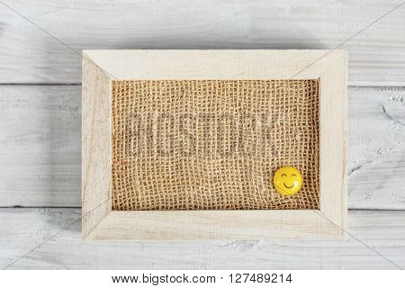Frame with smiles on a wooden board.