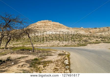 The desert landscape ruins of the ancient city on hill. Avdat Nabatean Town on the ancient spice route in the Negev Desert Israel