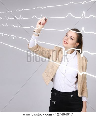 Doctor woman working with cardiogram lines