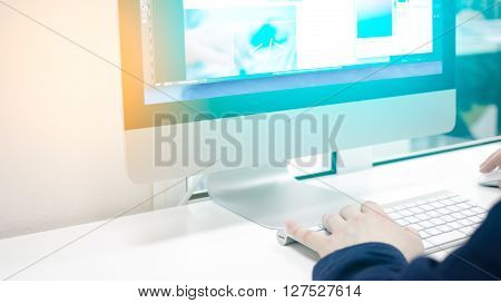 man sitting at a desktop computer in the office