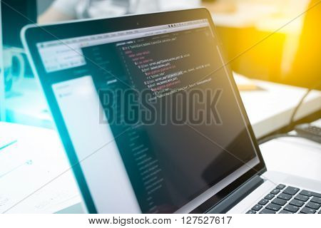 Web Developer's opened laptop with coding script