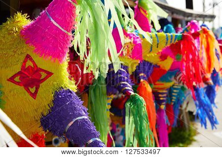 Mexican party pinatas decorated with fringed tissue colorful paper