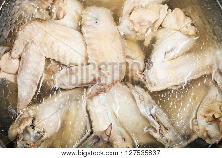 Boiled Chicken Wings In Greasy Bouillon In Stewpan