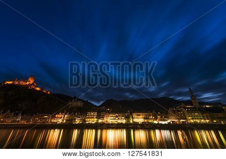 Cochem, Germany - March 28, 2016: View on Cochem at the Mossele in Germany at night with lights and a great castle Reichsburg.