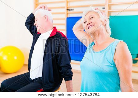 Senior people in fitness exercise doing gymnastic stretching