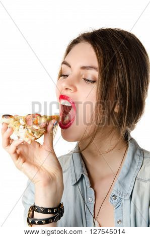 Pretty young sexy woman eating big slice of pizza with big opened mouth standing on white background