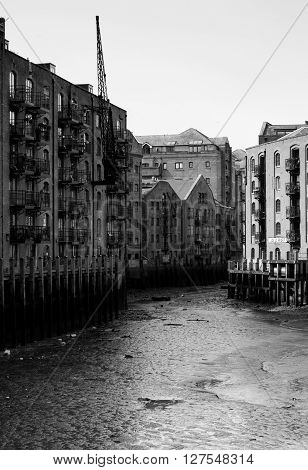 a black and white photo of the Java Wharf in the Shad Thames area of London