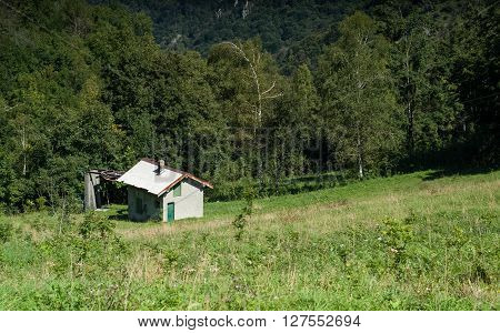 a solitary white house photographed at Piani d'Erna (part of the Alps) near Lake Como in Italy