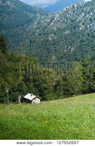 a solitary white house photographed at Piani d'Erna (part of the Alps) near Lake Como in Italy