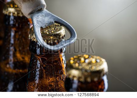 Brown Ice Cold Beer Bottles With Old Opener