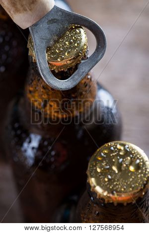Brown Ice Cold Beer Bottles With Old Opener