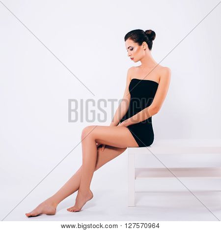 Beautiful Skinny Brunette Woman profile portrait. Beauty Luxury Makeup and Black Dress. Gorgeous Fashion Model Girl Portrait Isolated on a white background.