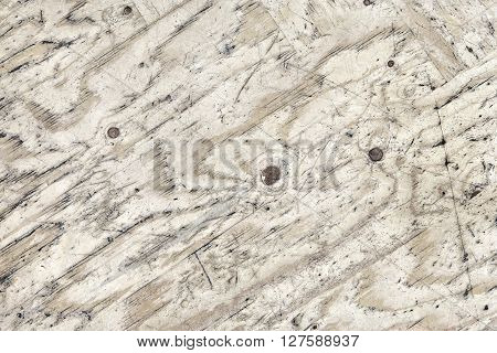 Surface fragment of heavily used pub table (covered with glued veneer plywood).